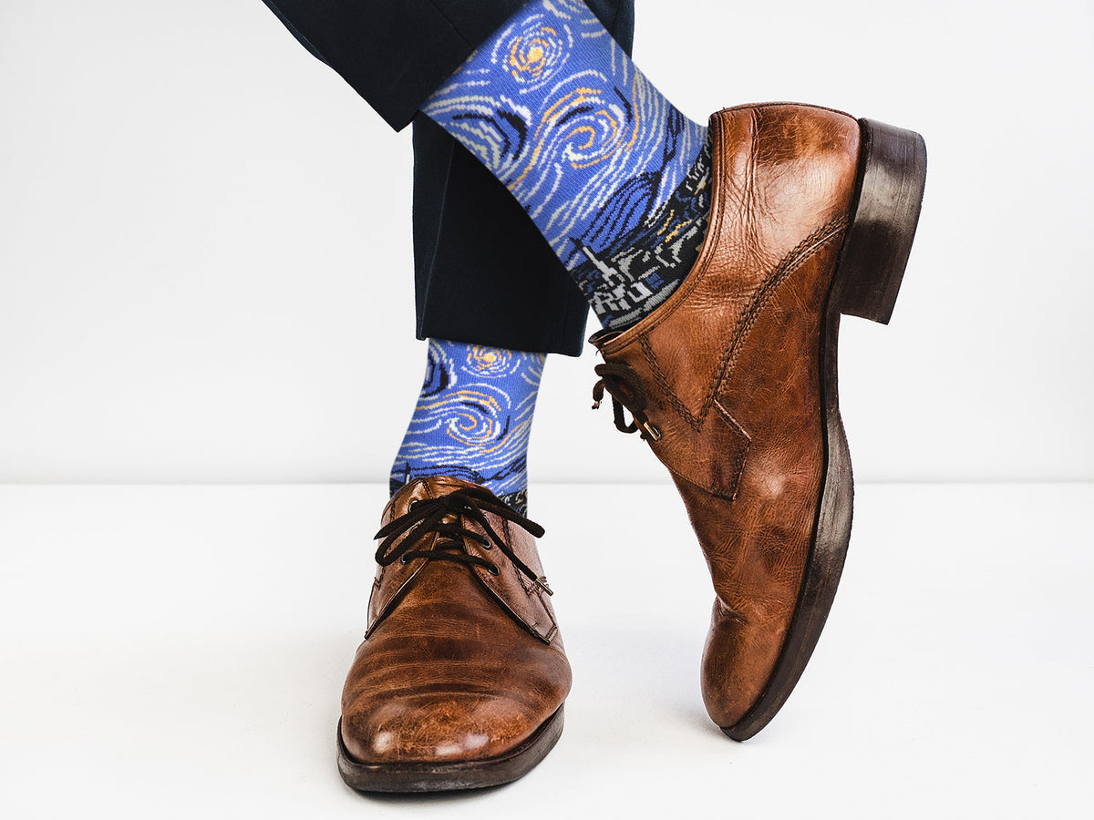 Starry Night socks worn with brown leather dress shoes and dark trousers.